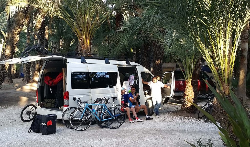 Mexico bicycle tour, Bicyclists resting in the support van during tour of Baja